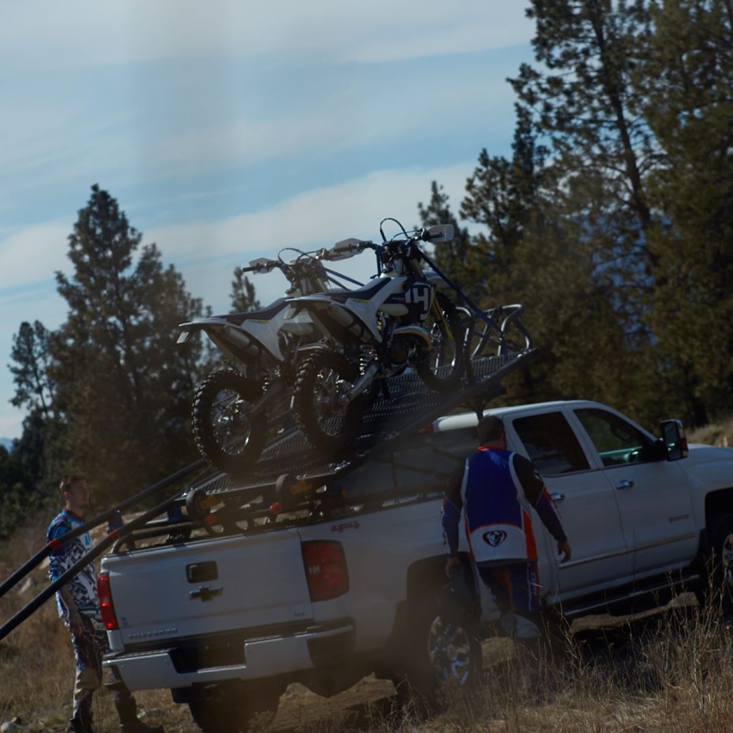Two dirt bikes, trailhead-ready
