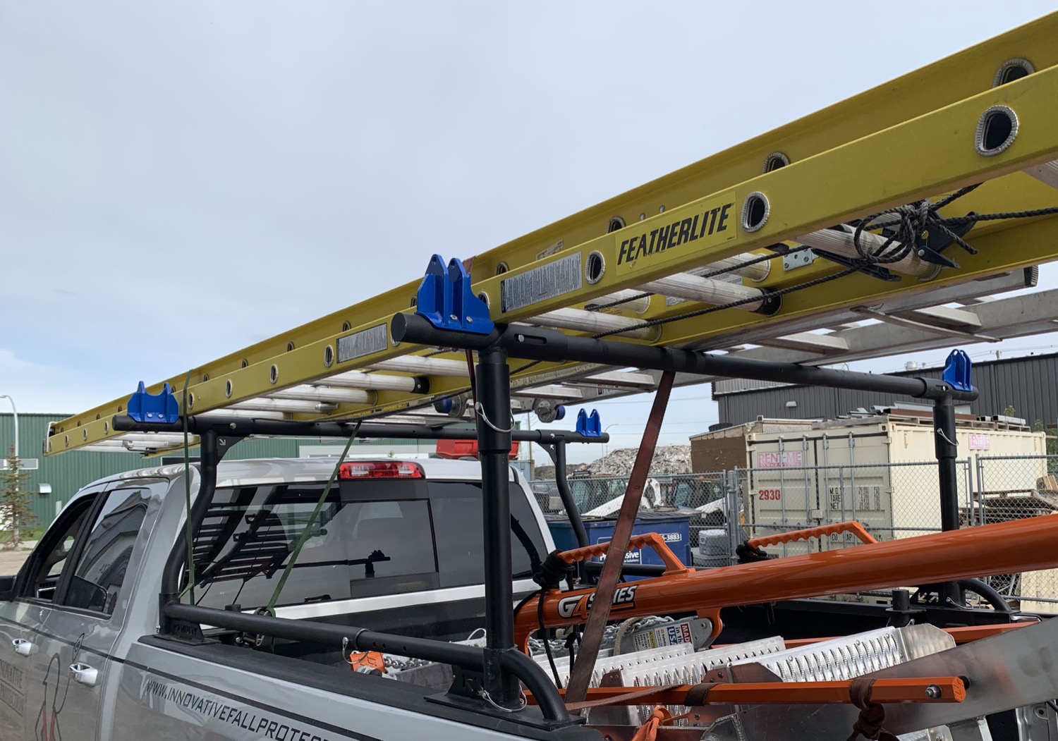 Frostrack prototype on a work truck carrying fiberglass ladders